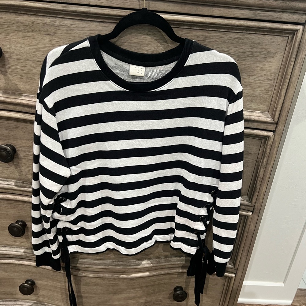 Striped black and white long sleeved top with ties at waist.